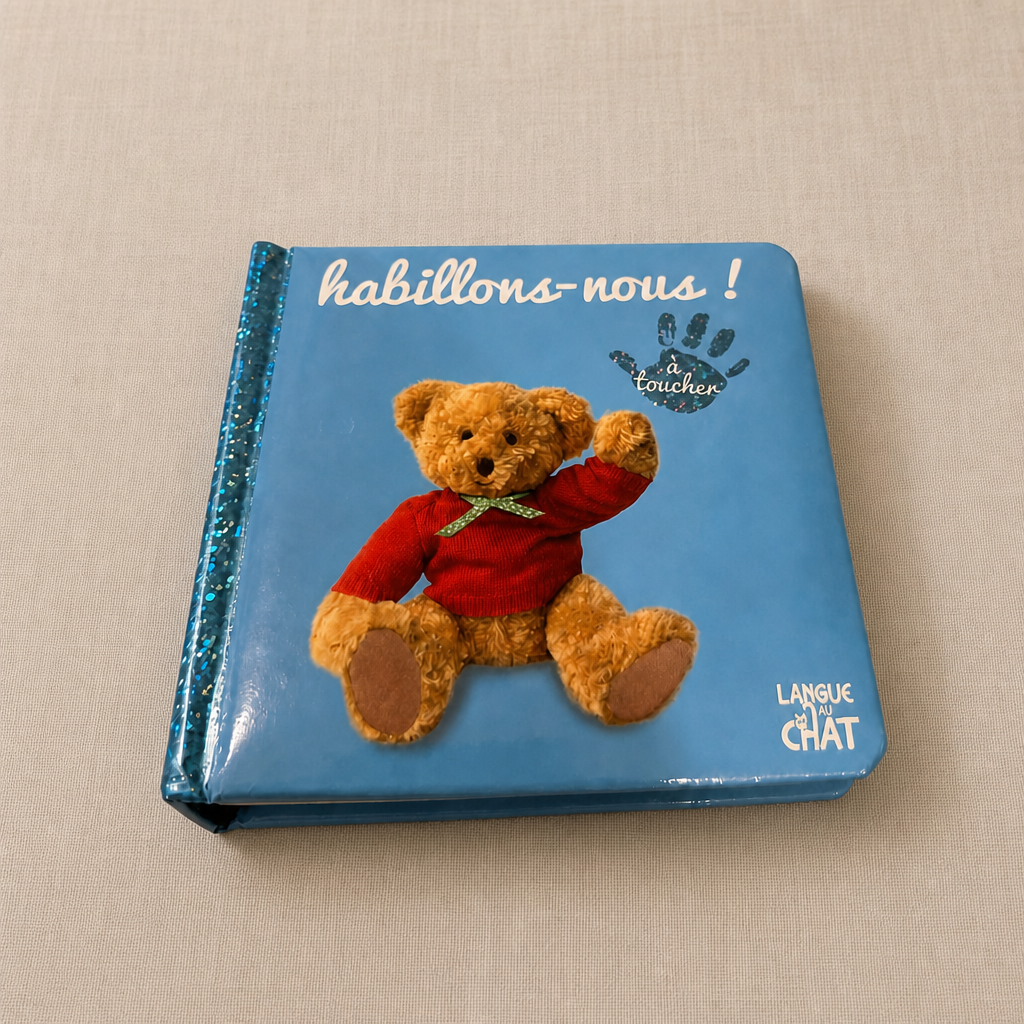 Libro bebé táctil con oso y ropa